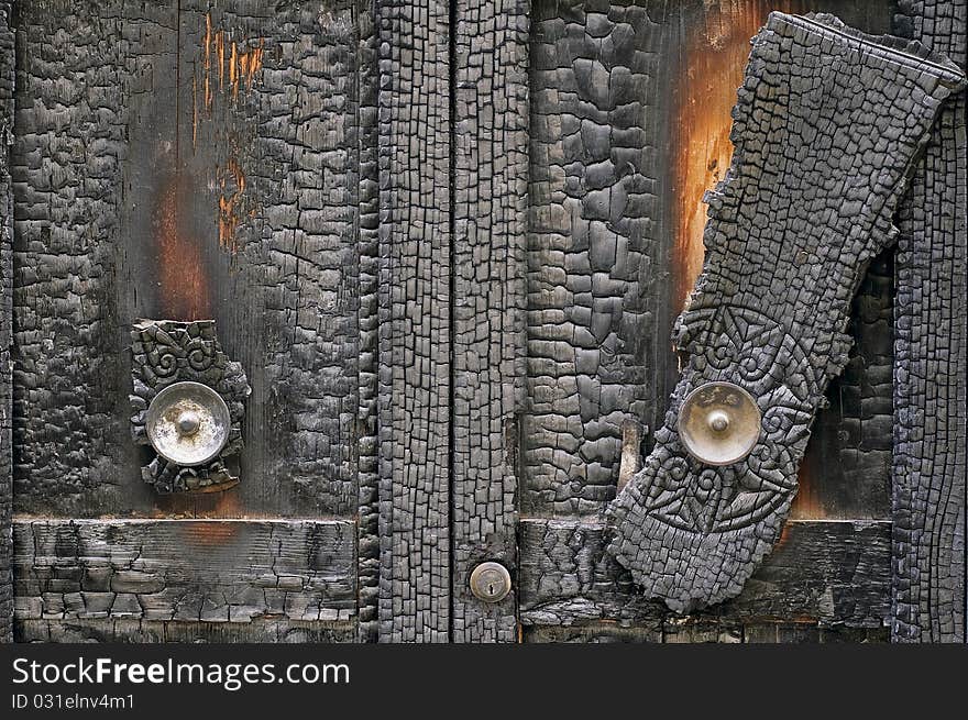 Detail of a burned door. Detail of a burned door