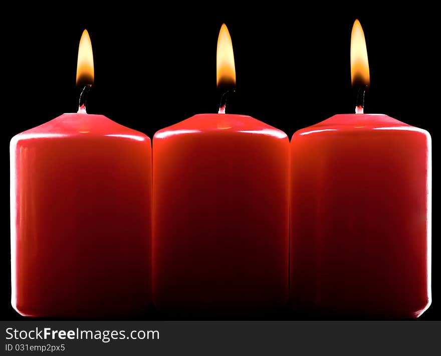 Three red burning candles over black. Three red burning candles over black