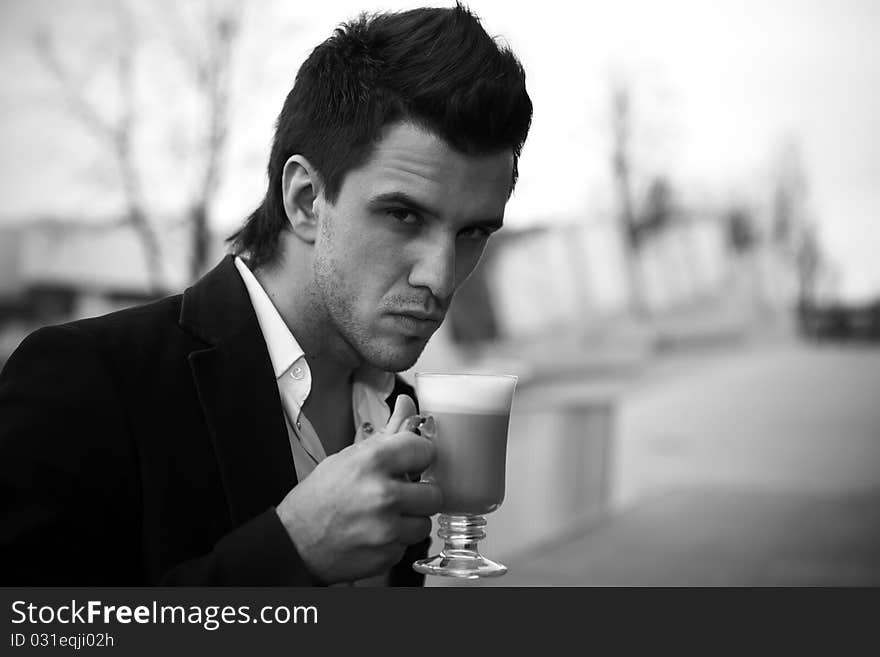 Portrait of Young attractive businessman drinking coffee