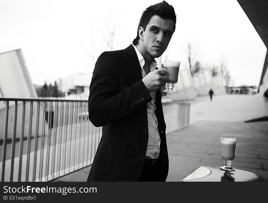 Portrait of Young attractive businessman drinking coffee