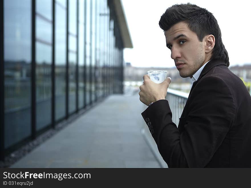 Portrait of Young attractive businessman drinking coffee