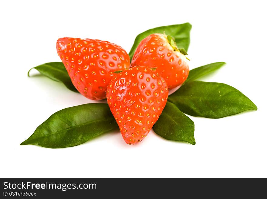 Photo of strawberries on green foils putted on white isolated background. Photo of strawberries on green foils putted on white isolated background