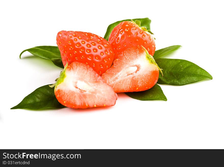 Photo of strawberries on green foils putted on white isolated background. Photo of strawberries on green foils putted on white isolated background