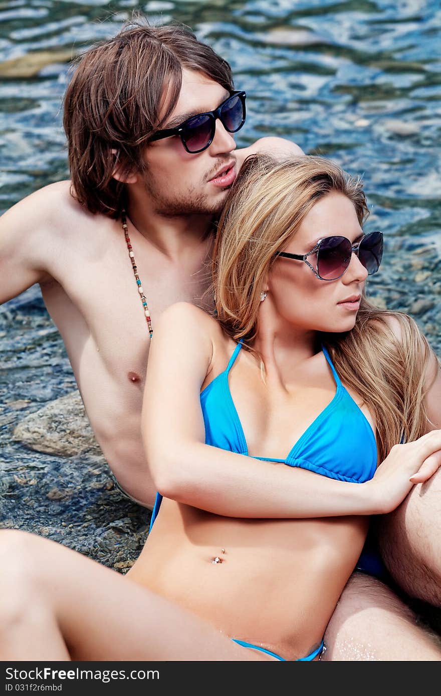 Happy young couple having a rest on a beach. Happy young couple having a rest on a beach.