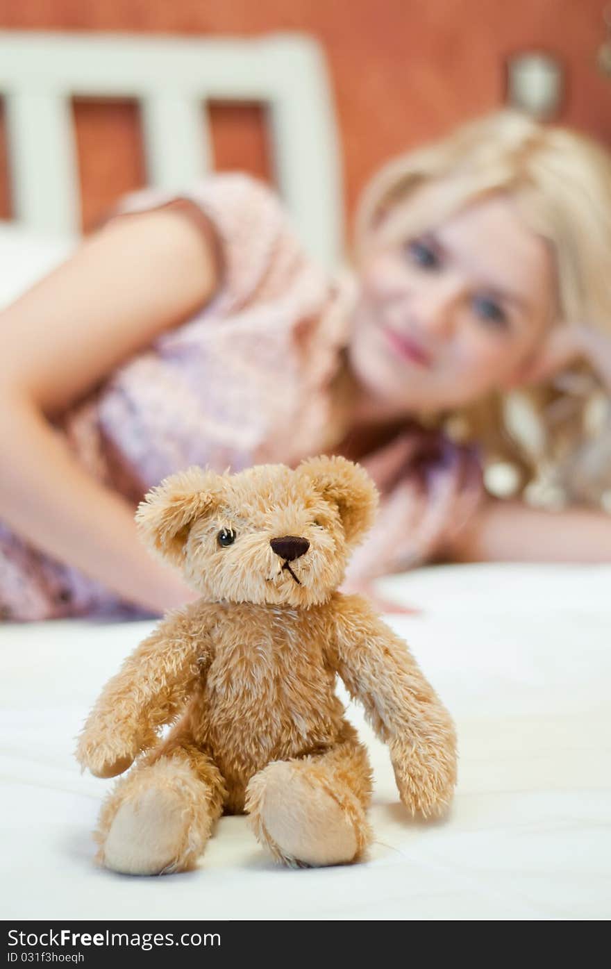 Beautiful young girl with bear toy in bed. Beautiful young girl with bear toy in bed