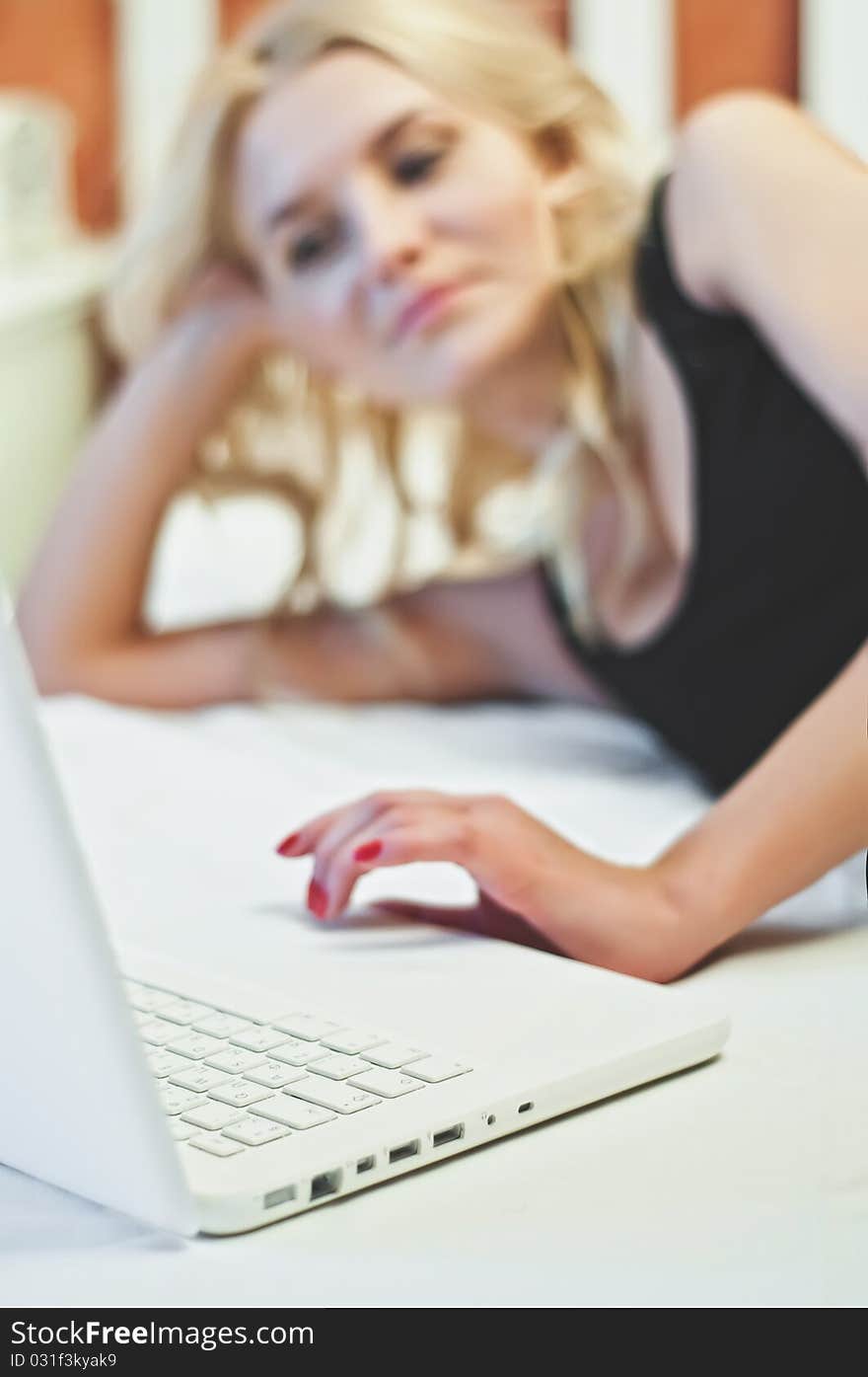 Young beautiful woman with white laptop in luxury room. Young beautiful woman with white laptop in luxury room