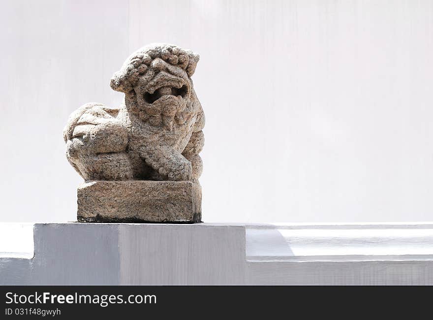 Sculpture of a lion and white wall. Sculpture of a lion and white wall.