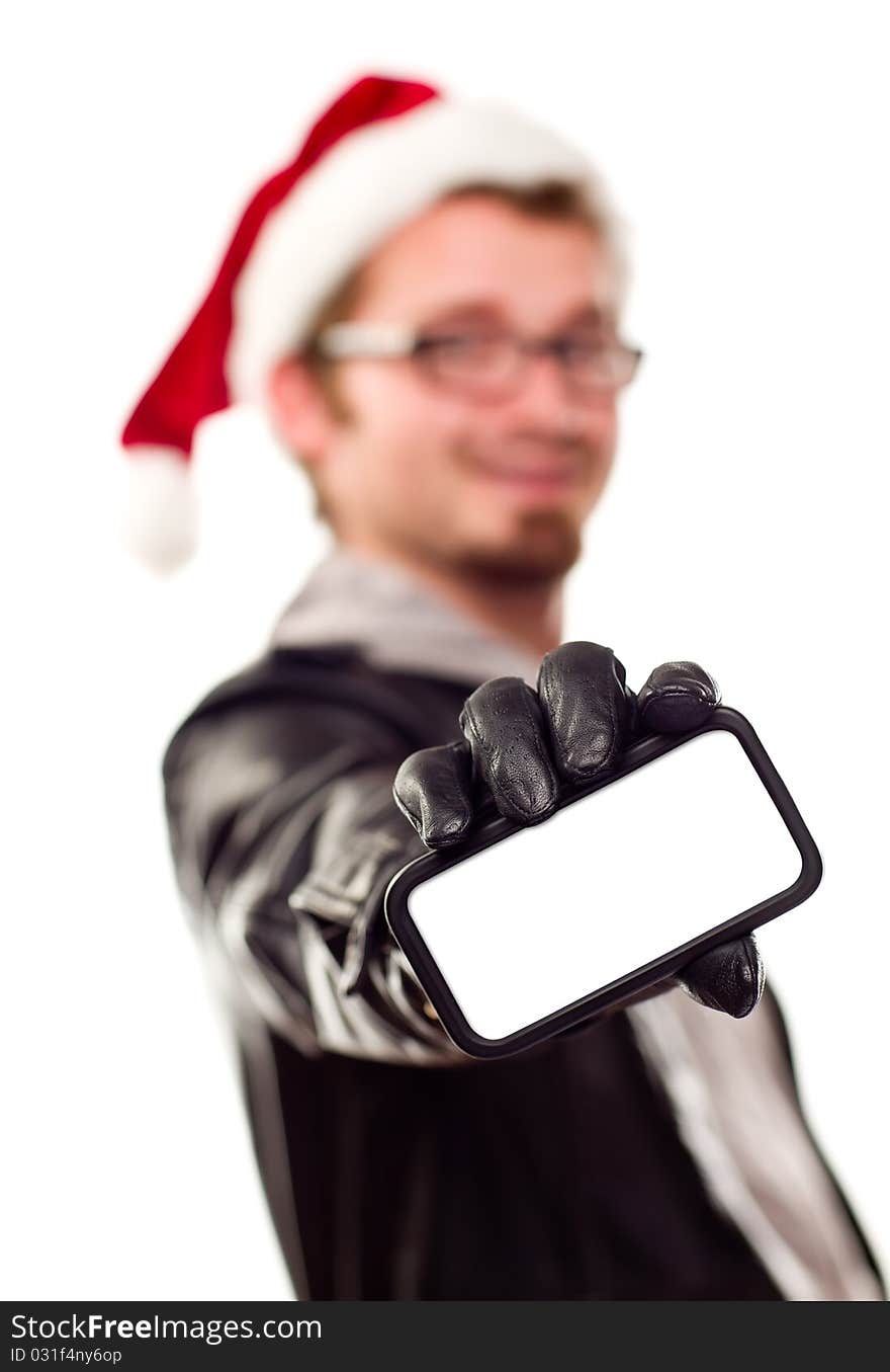 Smiling Young Man with Santa Hat Holding Out Blank Cell Phone Isolated on a White Background.