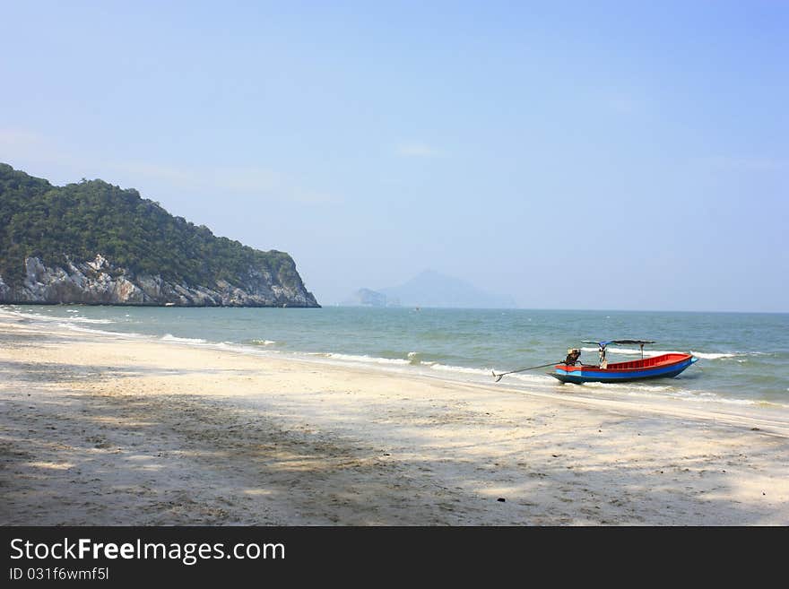 Boat parked along the beach shore. Boat parked along the beach shore