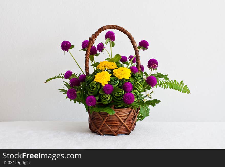 Colorful flowers in brown basket