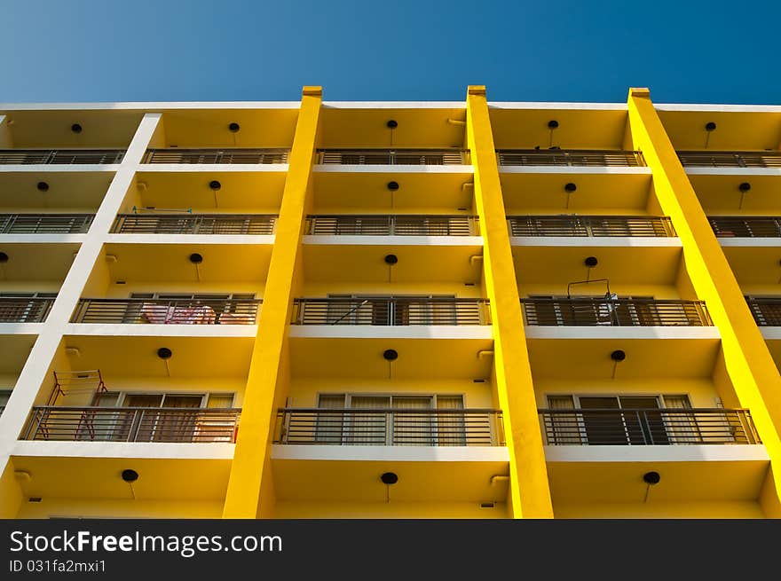 Yellow and white building and blue sky, Thailand.