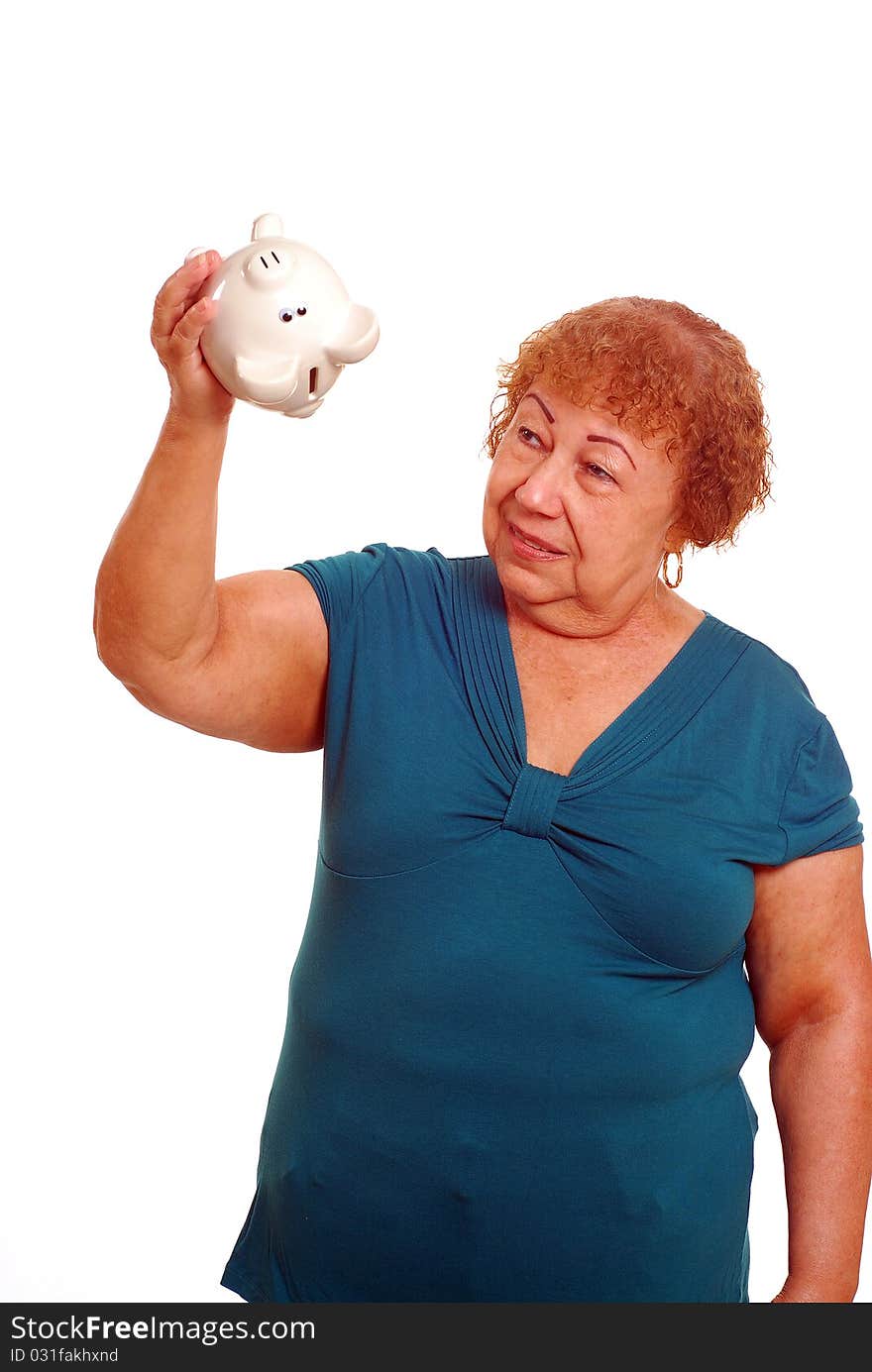 Hispanic female senior shaking piggy bank. Hispanic female senior shaking piggy bank