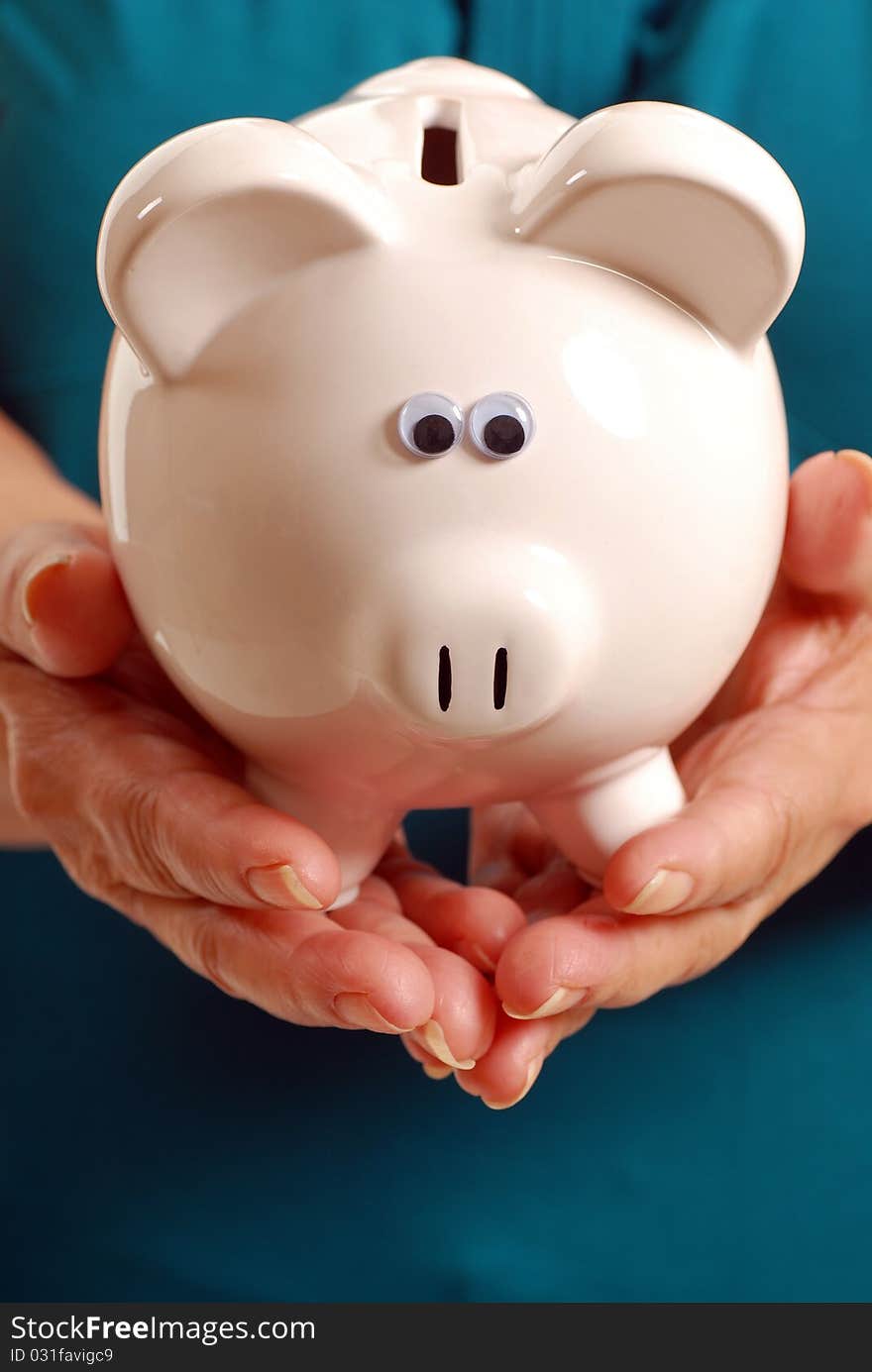 Hispanic female senior with piggy bank. Hispanic female senior with piggy bank