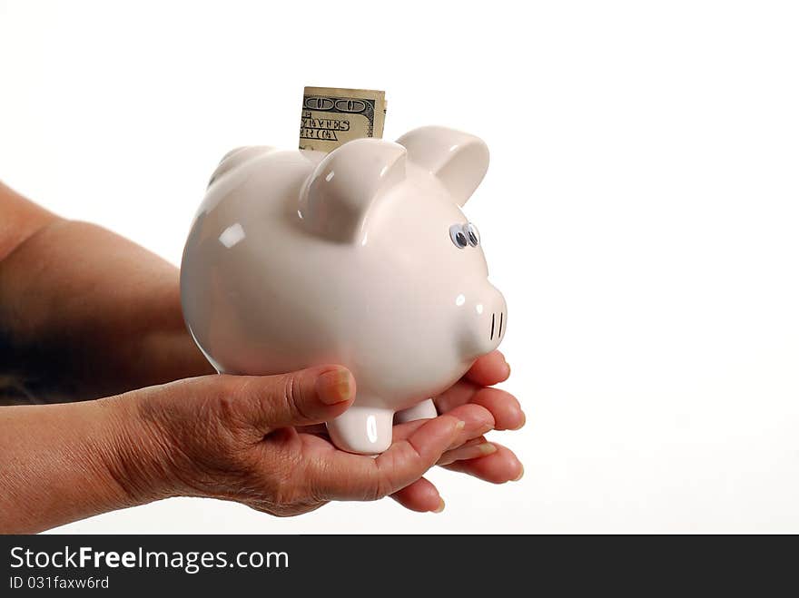 Hispanic female senior with piggy bank. Hispanic female senior with piggy bank