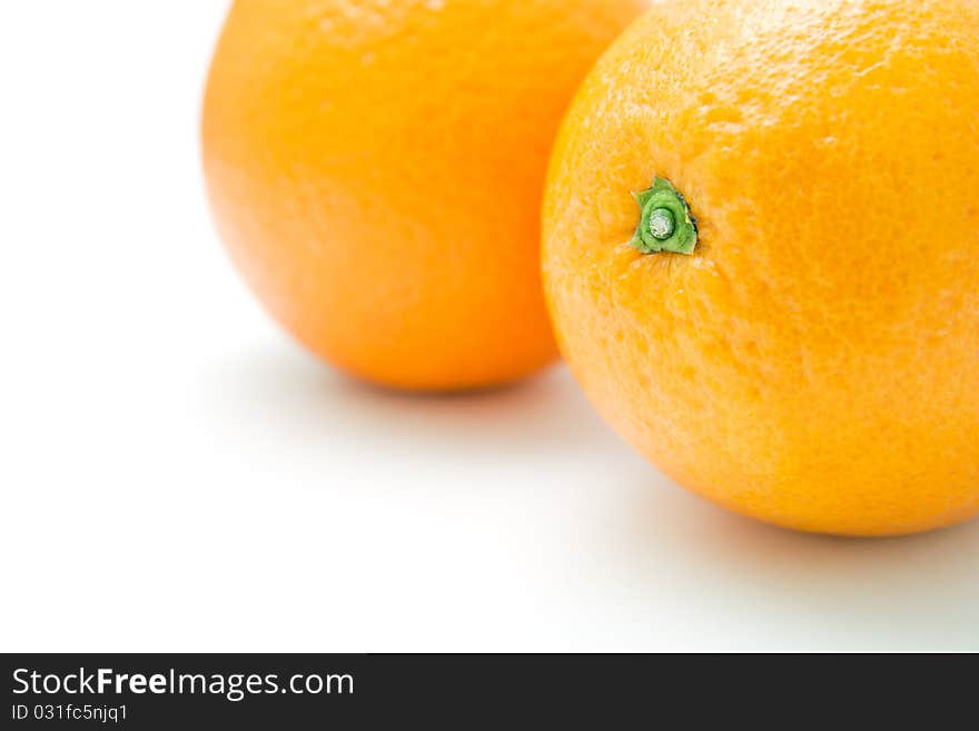 Two fresh oranges closeup on white background