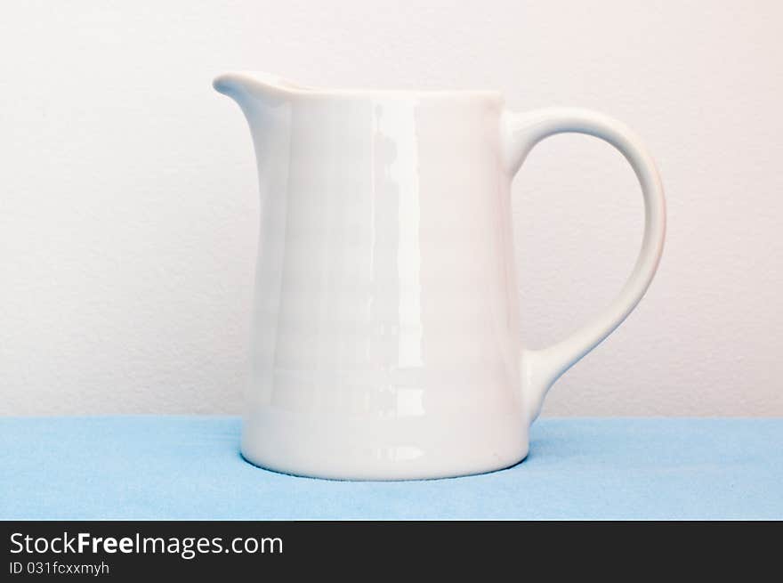 White cup on blue cloth