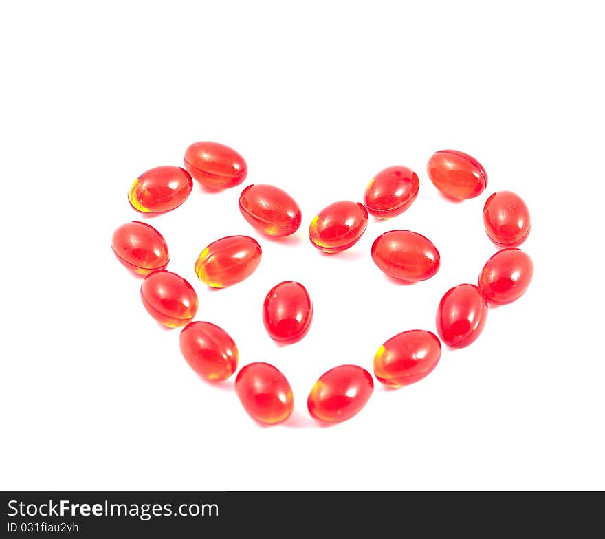 Heart of the red vitamins on a white background