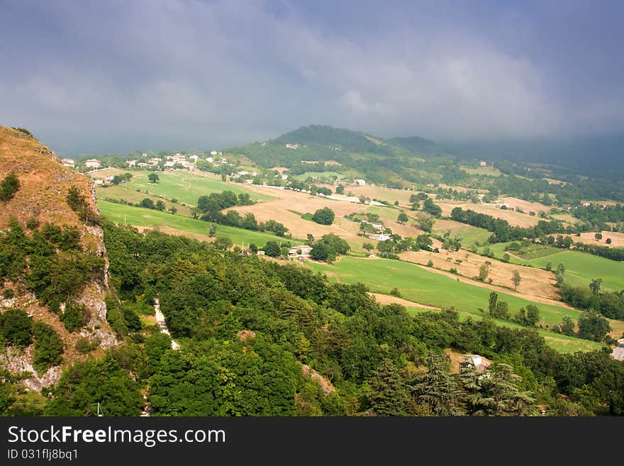 Hilly countryside of le Marche, Italy, with rainy sky