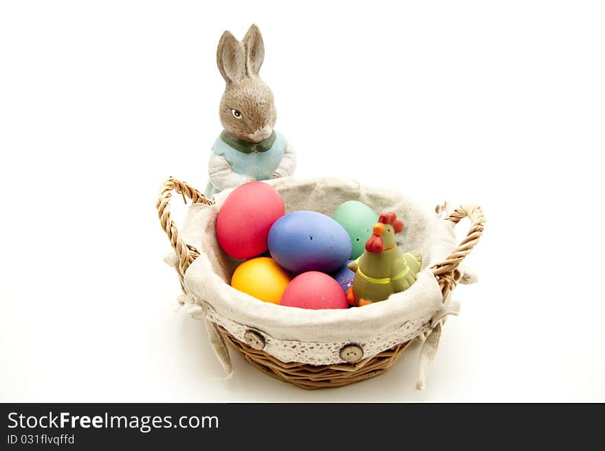 Colored eggs in the basket with Easter bunny