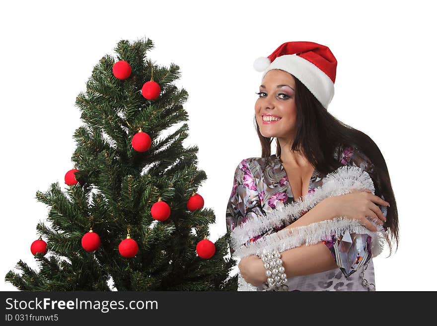 Woman in a christmas hat decorate a christmas tree. Woman in a christmas hat decorate a christmas tree