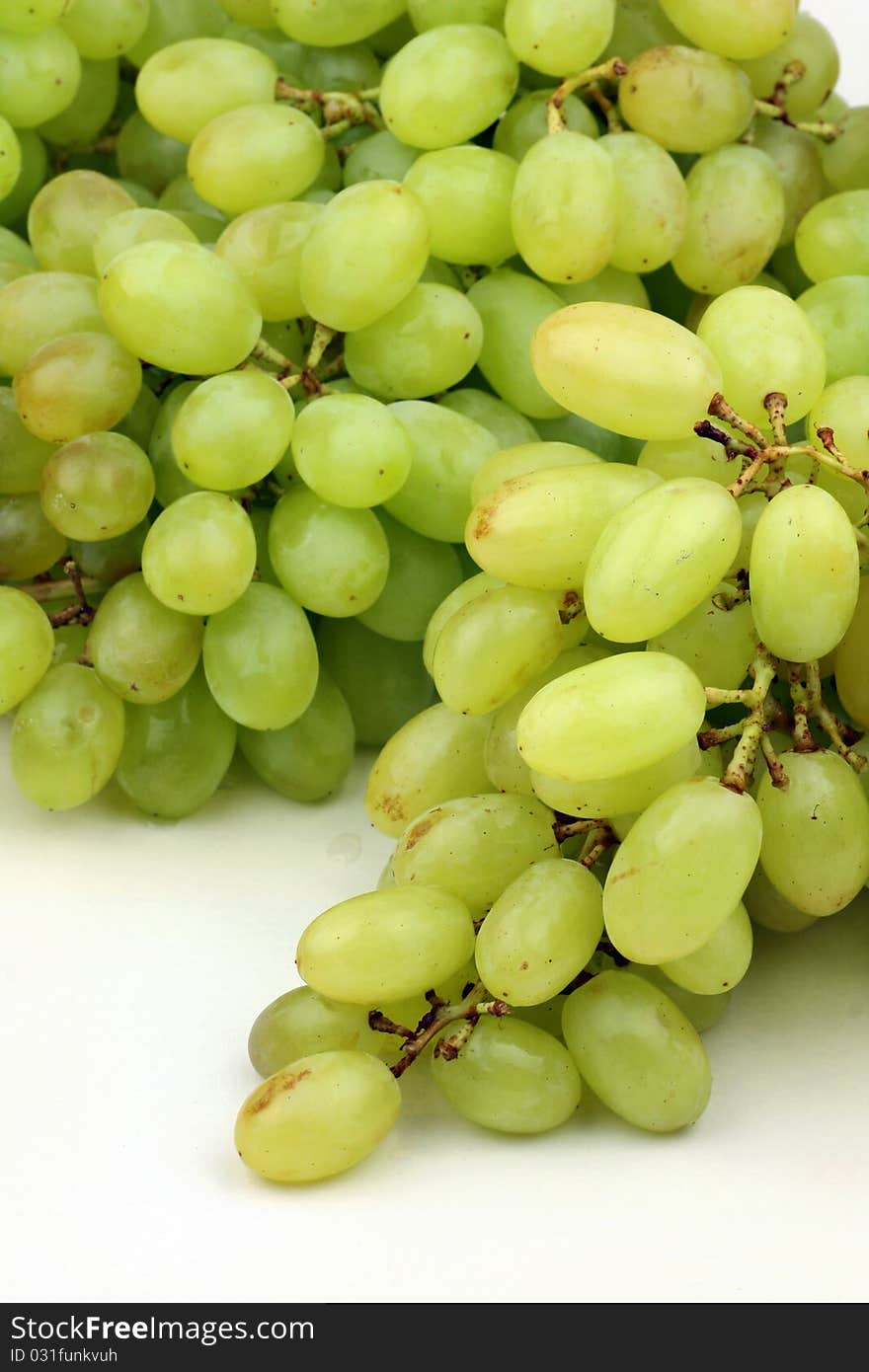 Green grapes on white background