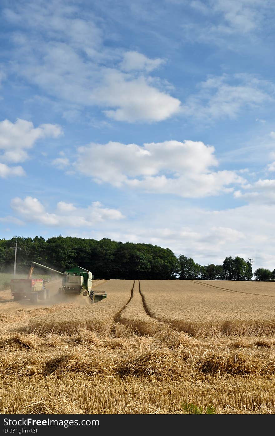 Farmers at work harvesting with tractors