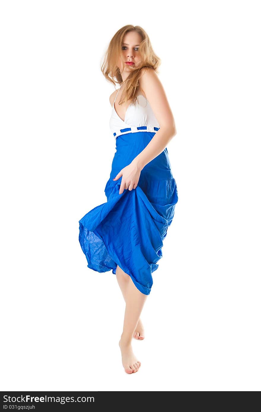 Barefooted girl in a blue dress isolated on a white background