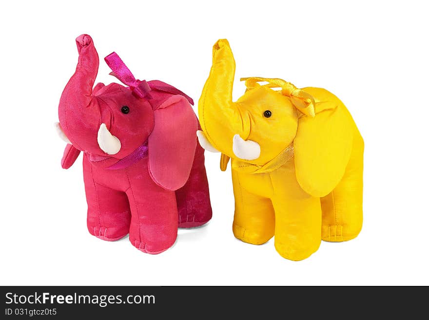 A pair of colorful toy elephants standing on a white background. A pair of colorful toy elephants standing on a white background