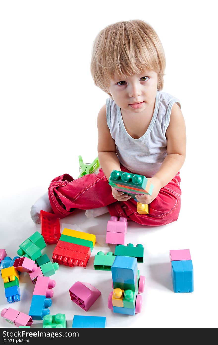 Little Boy Playing With Colorful Blocks