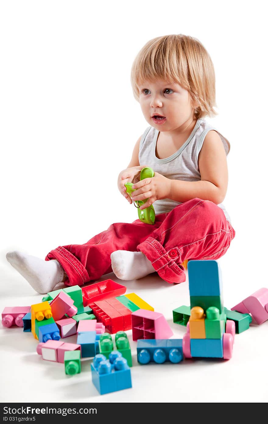 Cute Little Boy Playing With Colorful Blocks