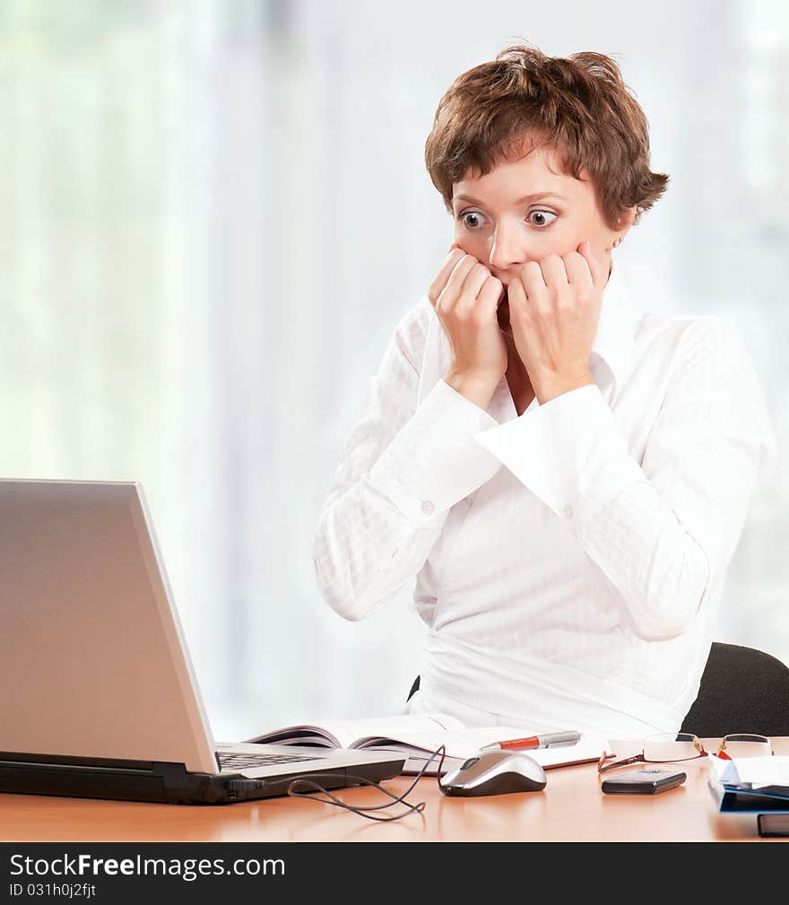 Beautiful businesswoman working with laptop at her office