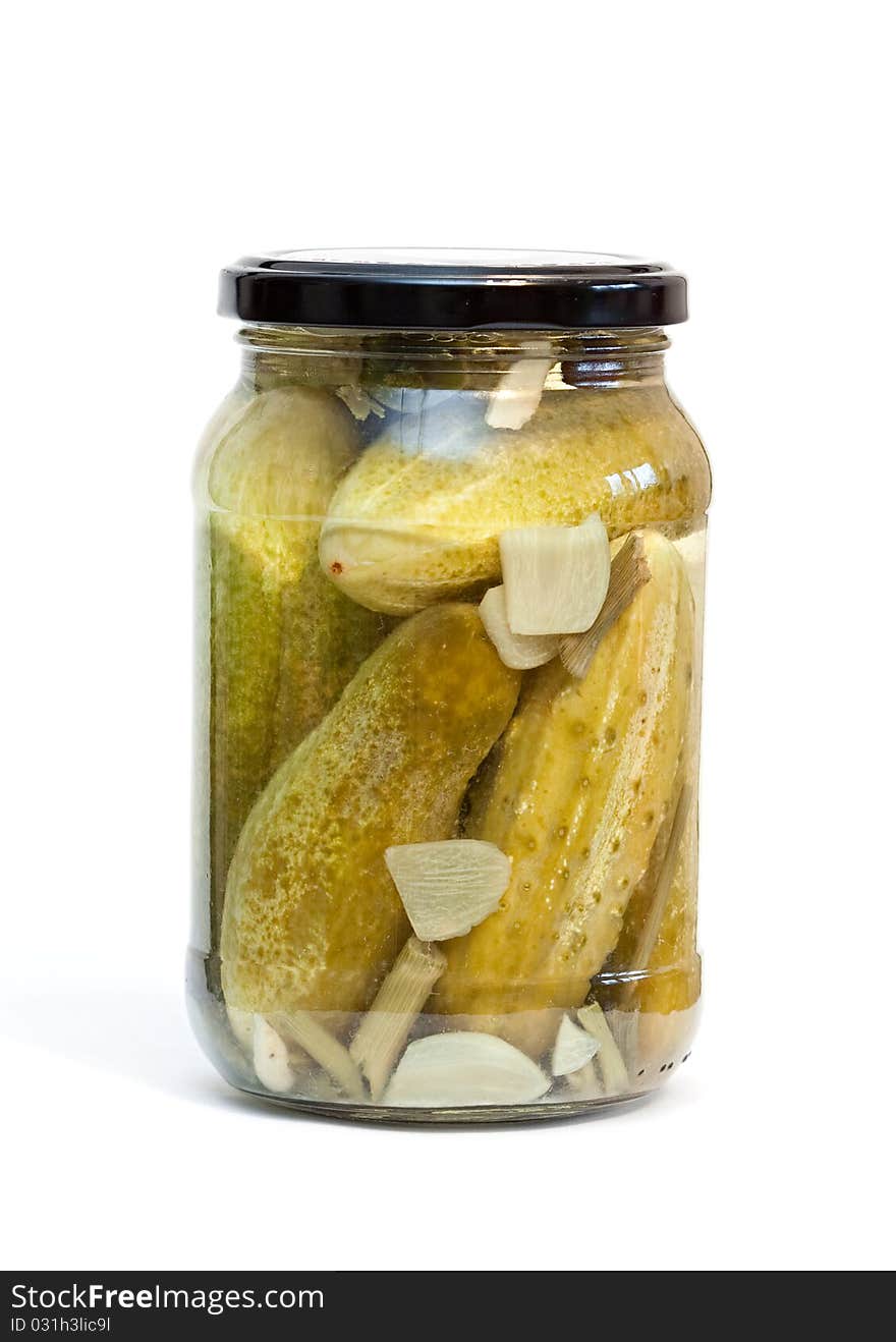 Glass jar with cucumbers on a white background. Glass jar with cucumbers on a white background.