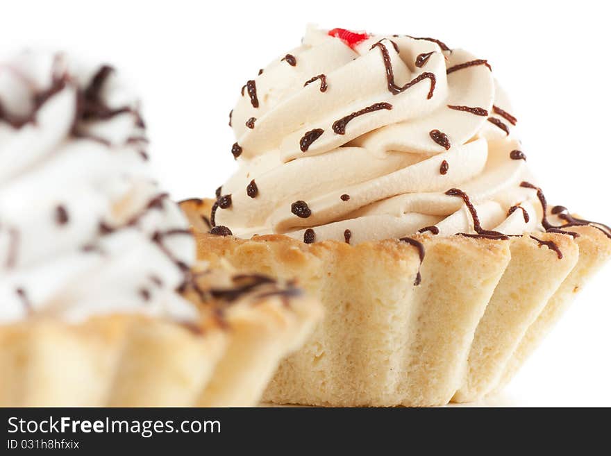 Macro view of cake with whipped cream isolated over white