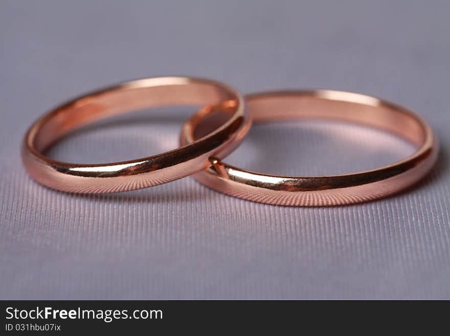 Closeup wedding rings on silk background