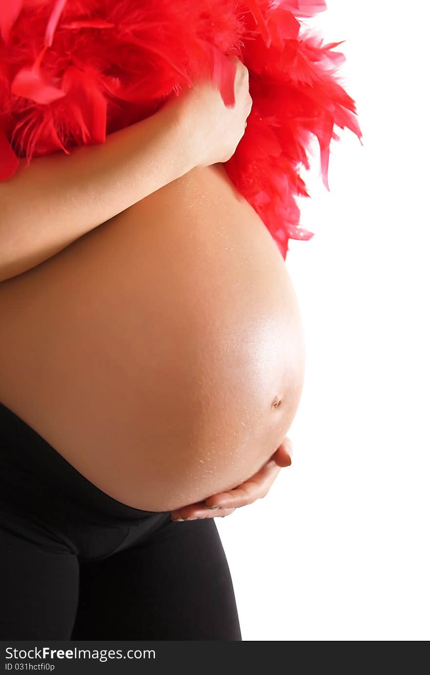 Pregnant woman holding her belly and feather