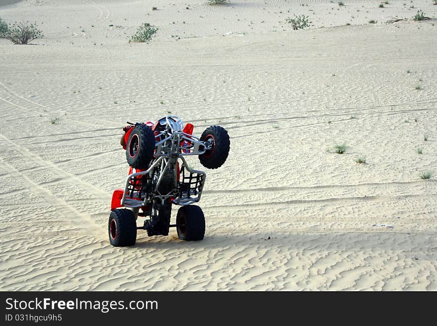 Adventure and adrenaline in the sand with a car on two wheels