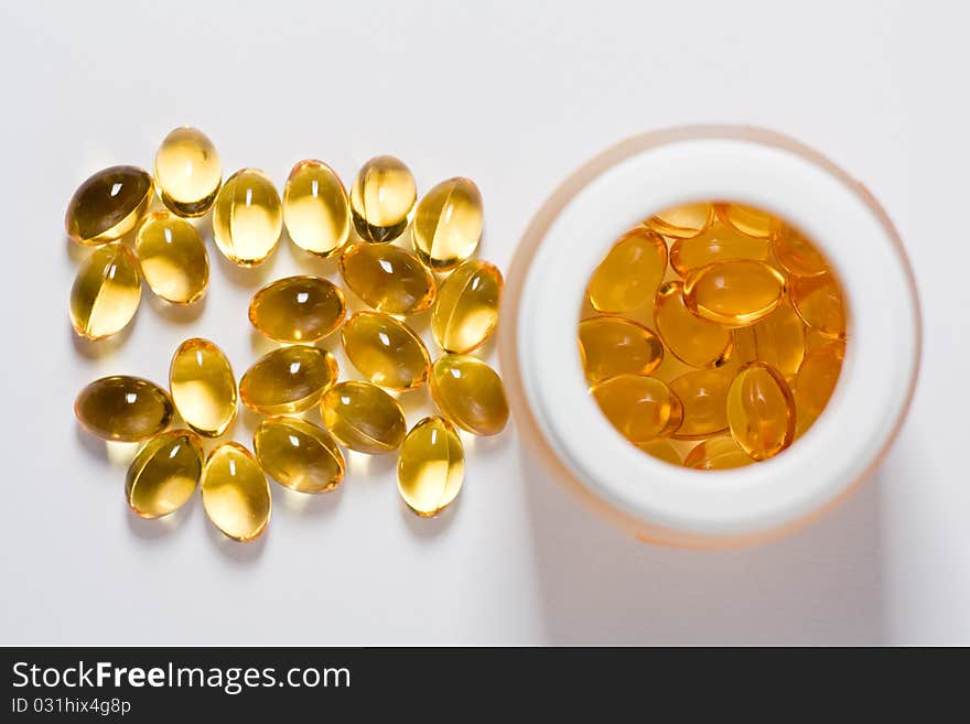 Yellow tablets with a tube on a white background