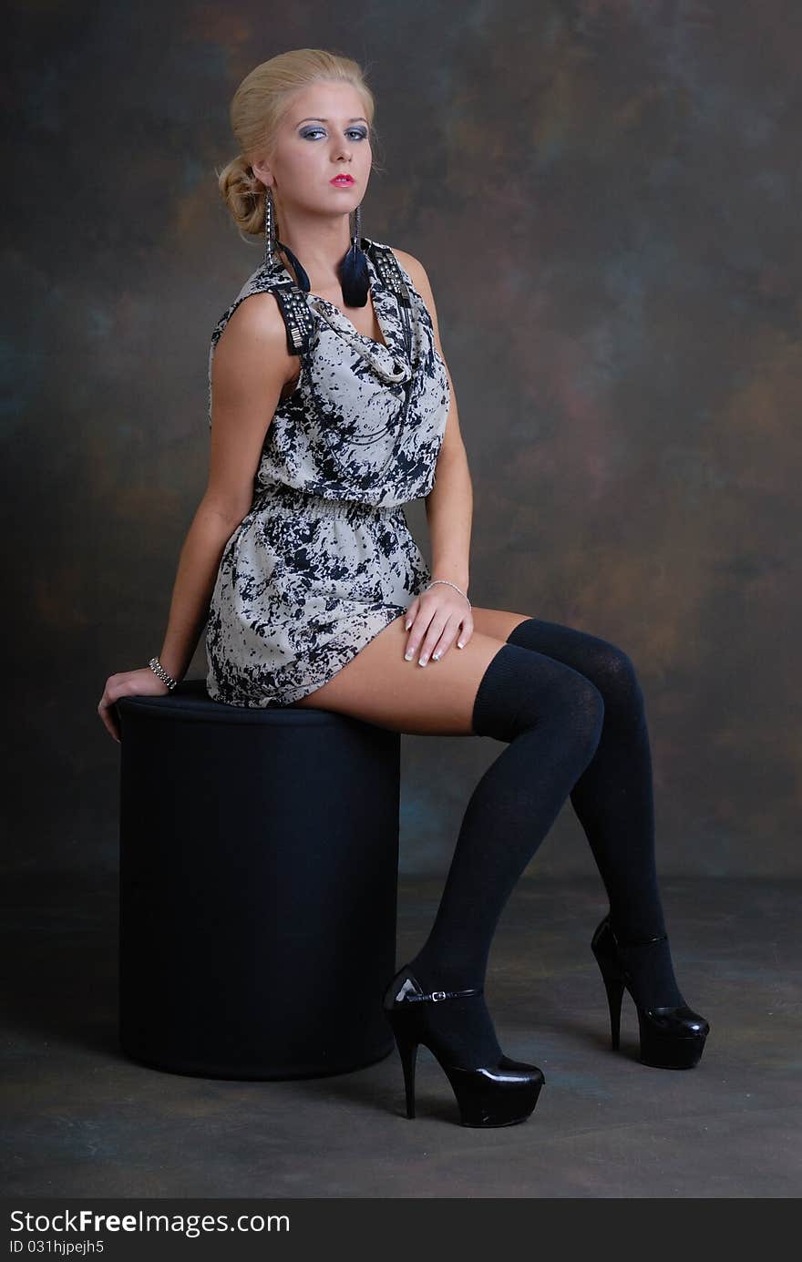 Photograph of beautiful young woman in dress and stockings