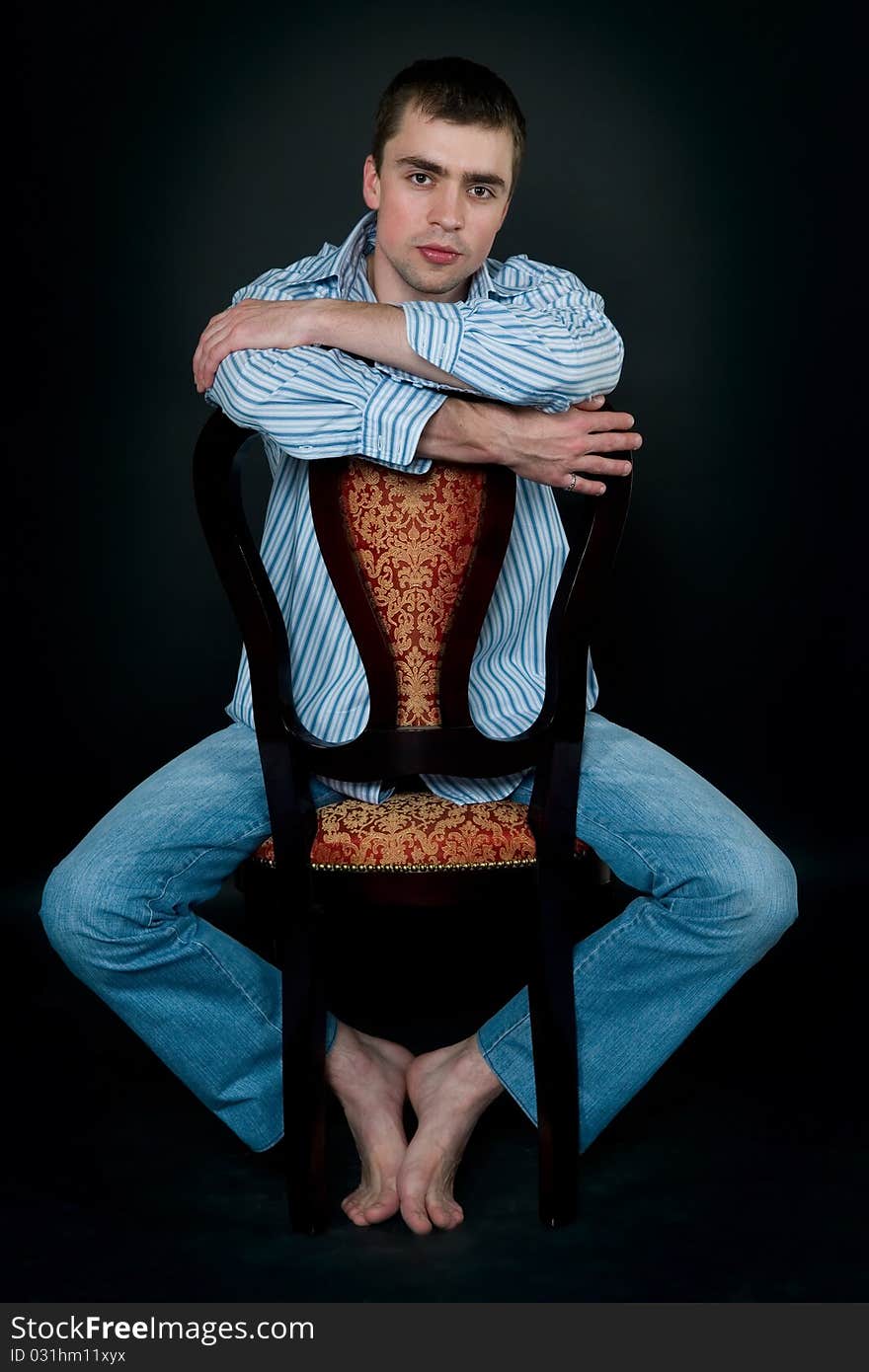 Young man sitting on a chair