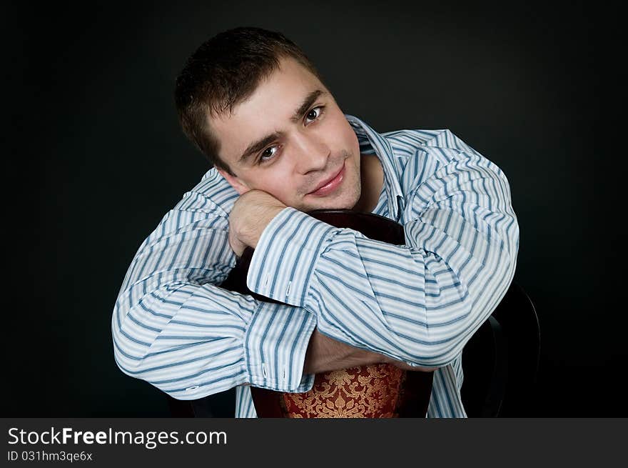 Young man sitting on a chair