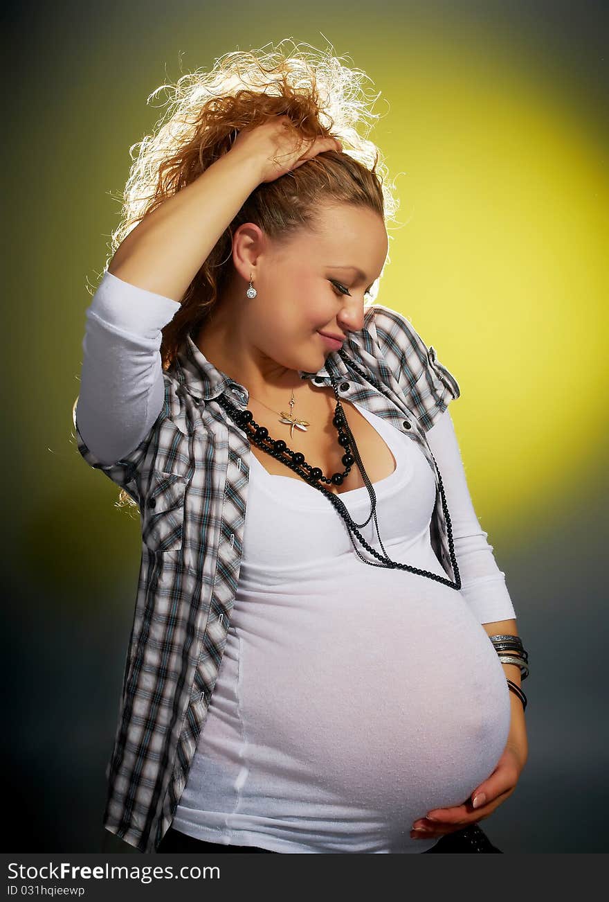 Beautiful pregnant woman in the studio