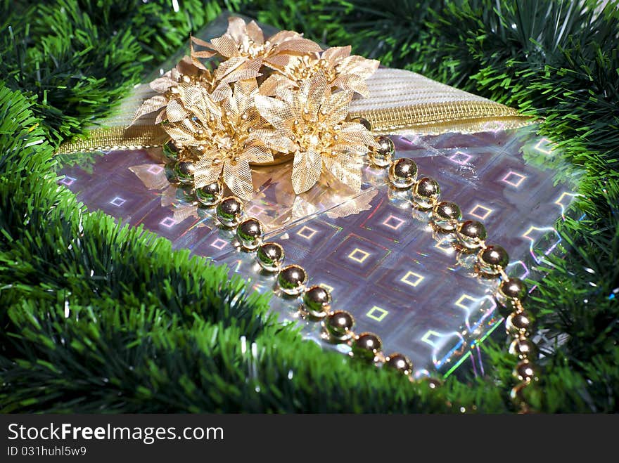 Beautifully wrapped gift box with gold flowers and ribbons