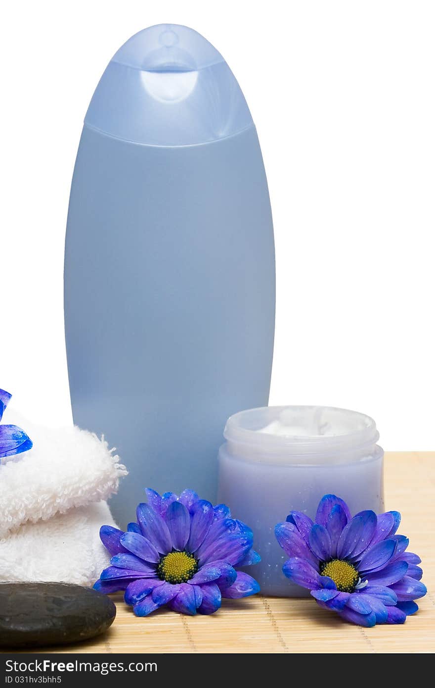 Spa essentials, cream and towel with blue flowers