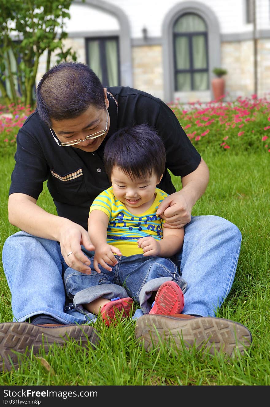 Happy baby is playing with his father.