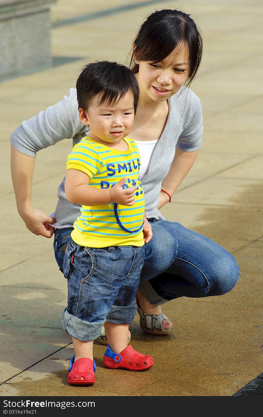 Happy baby is playing with his mother