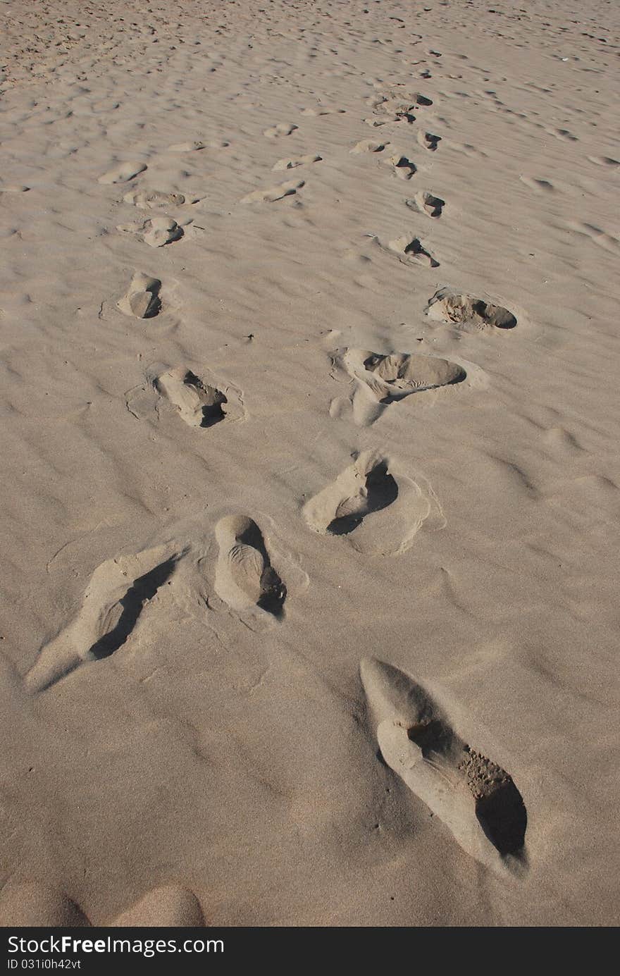 Crisscros footprints in sand