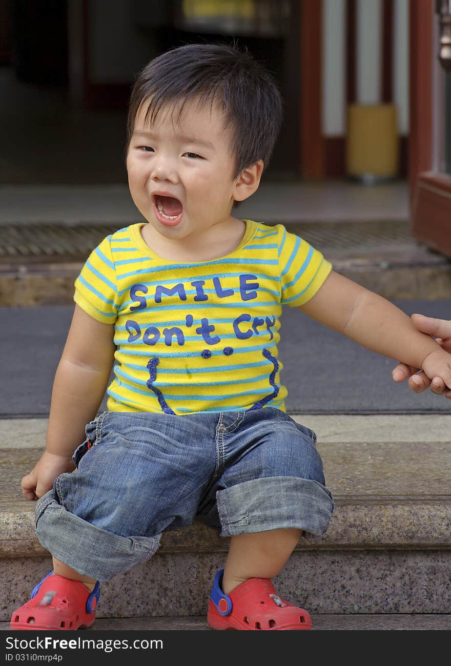 A baby is playing in a garden. A baby is playing in a garden