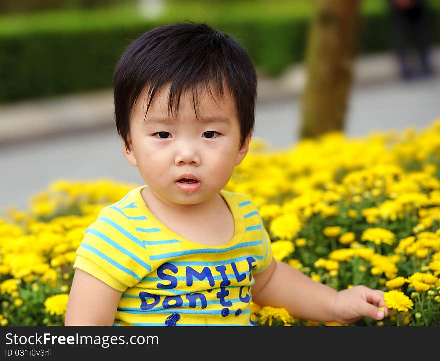 A cute baby is playing in garden