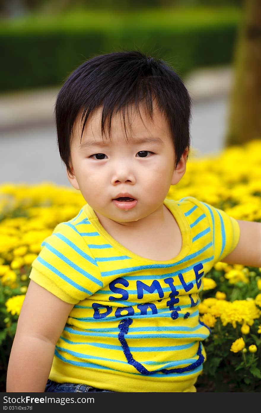 A cute baby is playing in garden. A cute baby is playing in garden