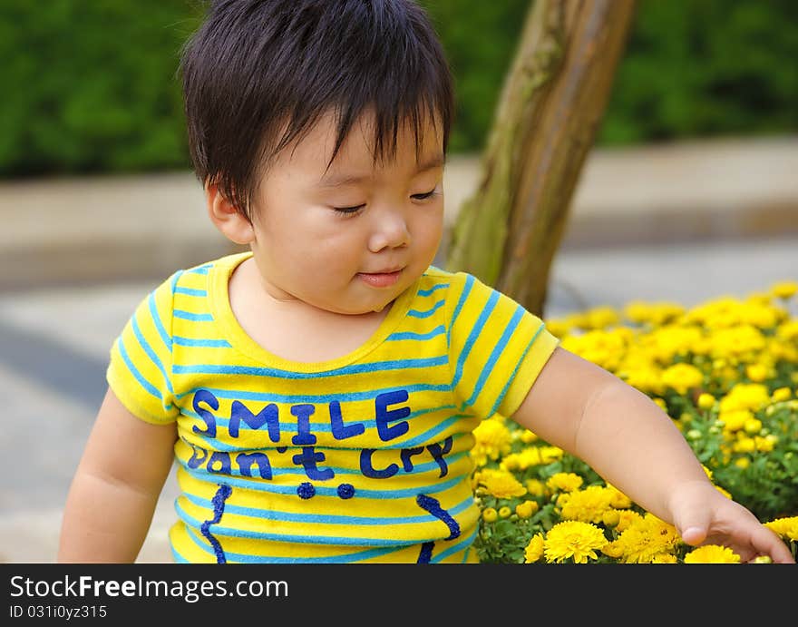 A cute baby is playing in garden